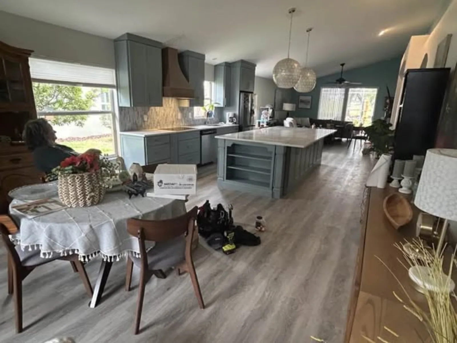 Sage open floor plan kitchen with hardwood-look flooring